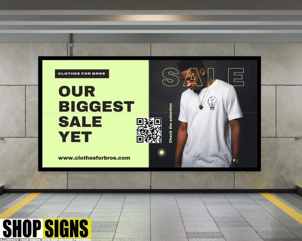 LED video wall advertising fashion sale in a London underground station with QR code and bold text